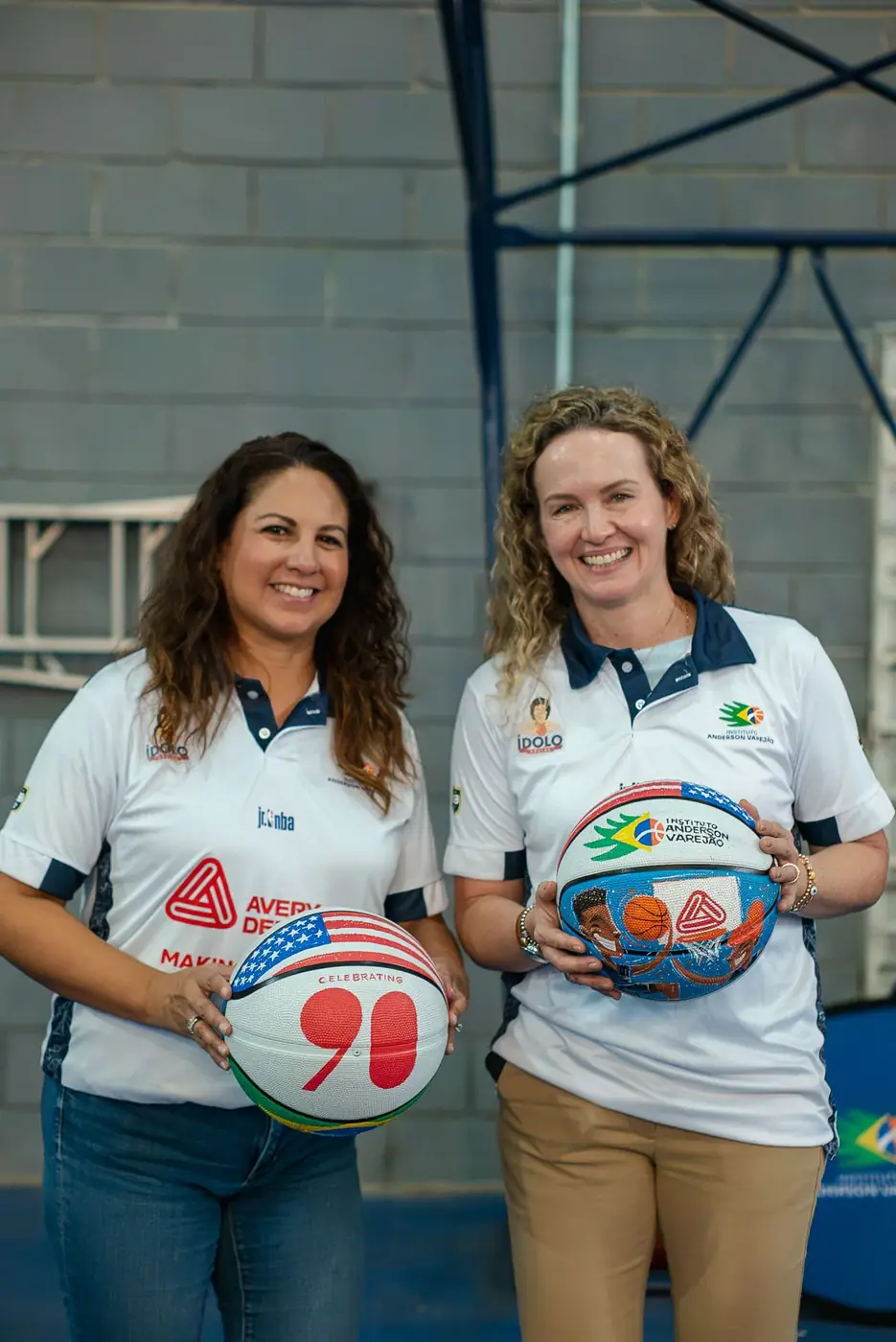 Isabela Galli and Janet Sandoval holding basketballs